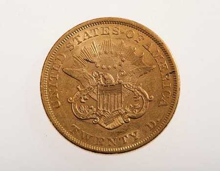 The backside of a gold coin minted in 1858.